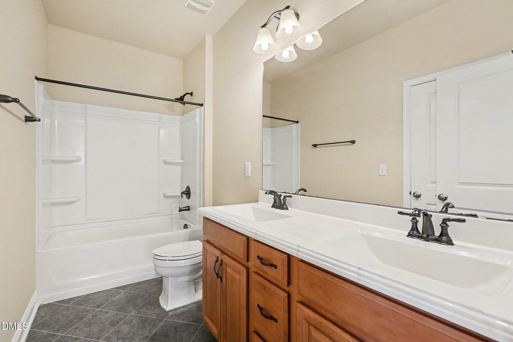 351 Gartrell Way Cary, NC 27519 - Photo 27 of 51 a bathroom with a sink a toilet and a large mirror
