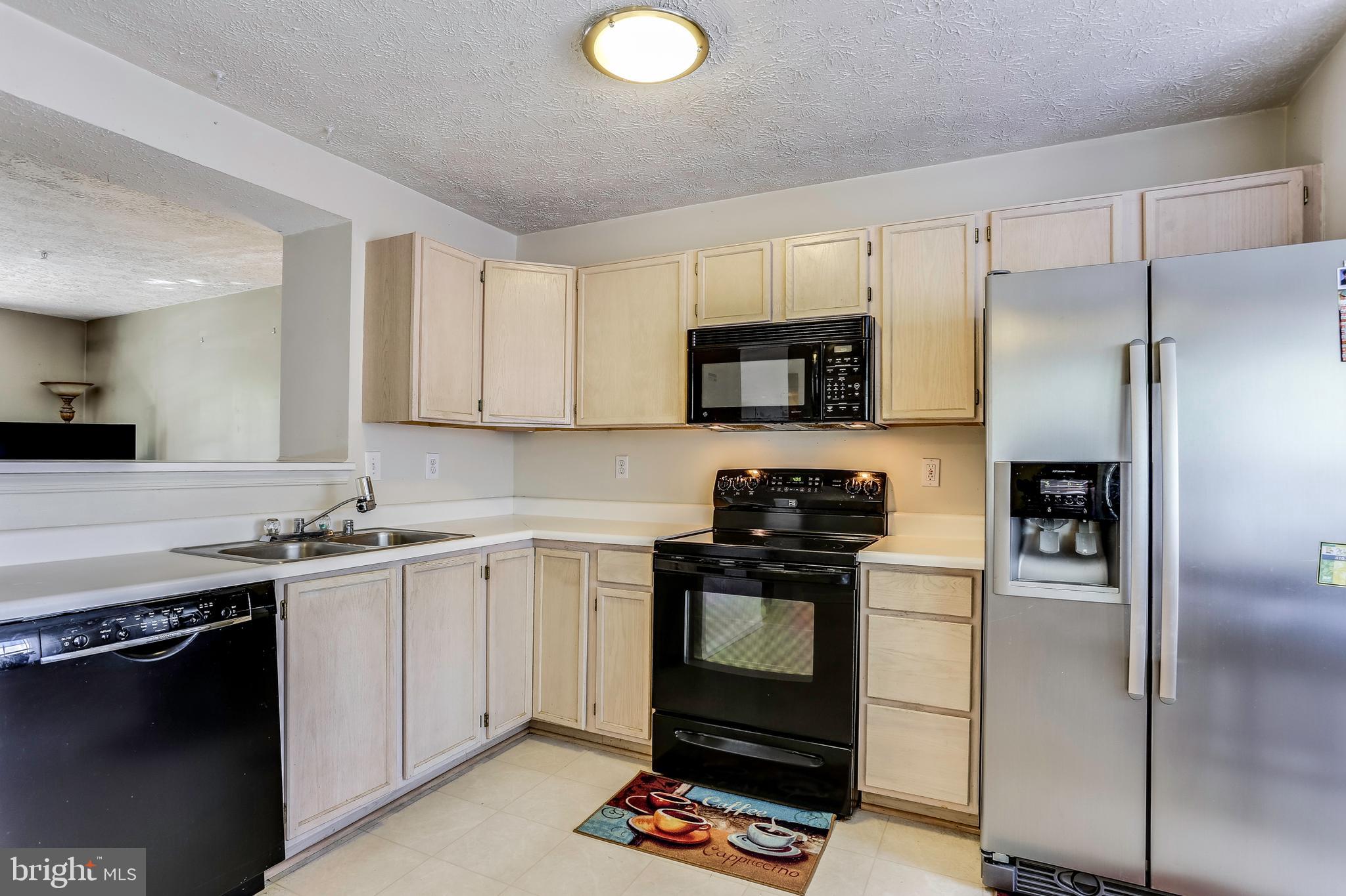 2075 Paperbark Road Baltimore, MD 21221 - Photo 7 of 22 a kitchen with stainless steel appliances granite countertop a stove a refrigerator and a sink