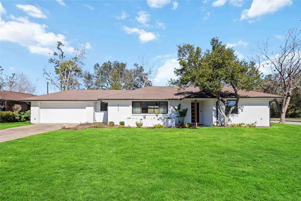 a view of a house with a yard and sitting area