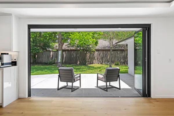 a view of a dining room with furniture and wooden floor