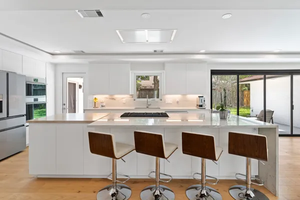 a view of kitchen with stainless steel appliances cabinets and outdoor space