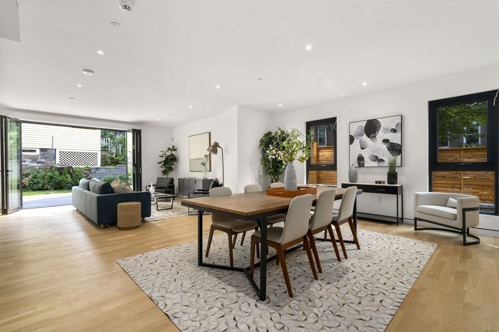 a living room with furniture a rug and a large window