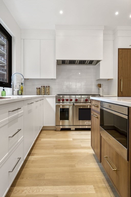 41 Stearns Road, Unit SF Brookline, MA 02446 - Photo 5 of 26 a kitchen with stainless steel appliances granite countertop a stove a sink and a refrigerator