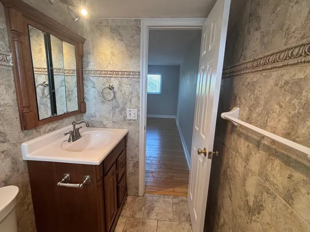 a bathroom with a sink a toilet and a mirror