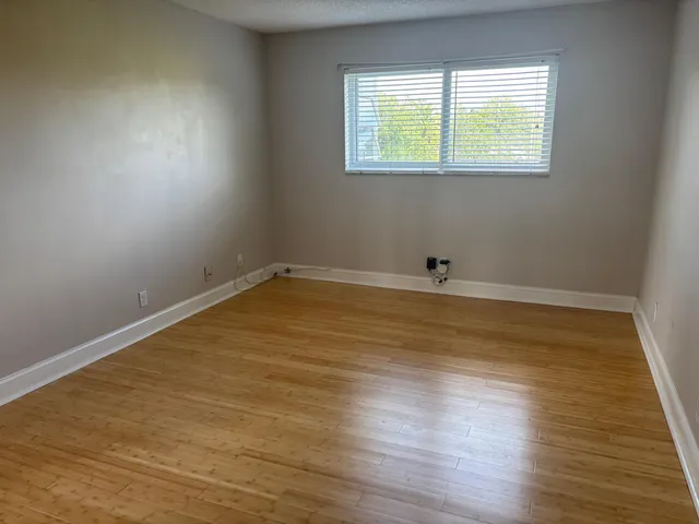 a view of a room with wooden floor and window