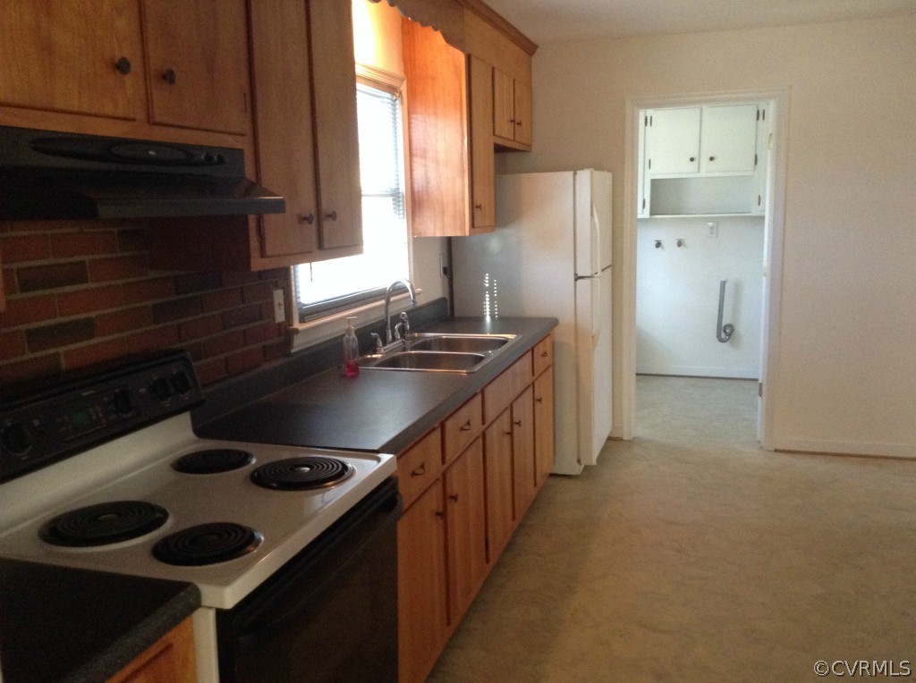 9513 Beach Road Chesterfield, VA 23838 - Photo 5 of 14 a kitchen with a sink stove and refrigerator