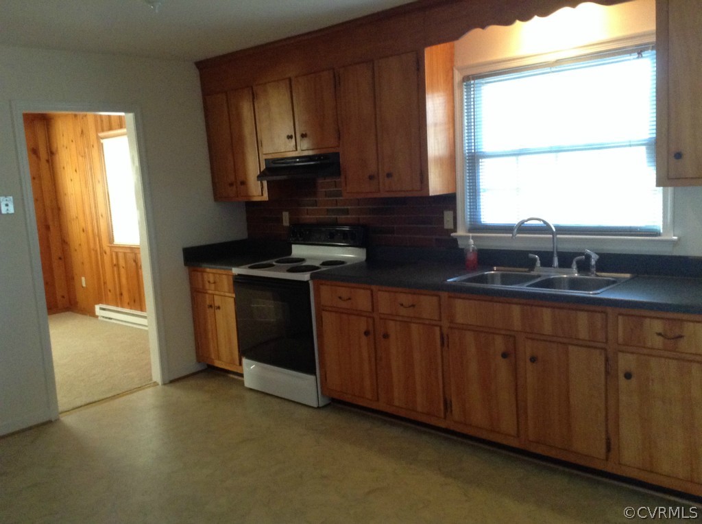 9513 Beach Road Chesterfield, VA 23838 - Photo 6 of 14 a kitchen with stainless steel appliances granite countertop wooden cabinets a stove a sink and a window
