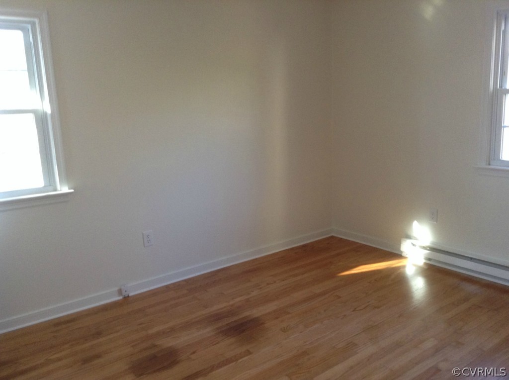 9513 Beach Road Chesterfield, VA 23838 - Photo 10 of 14 an empty room with wooden floor and windows