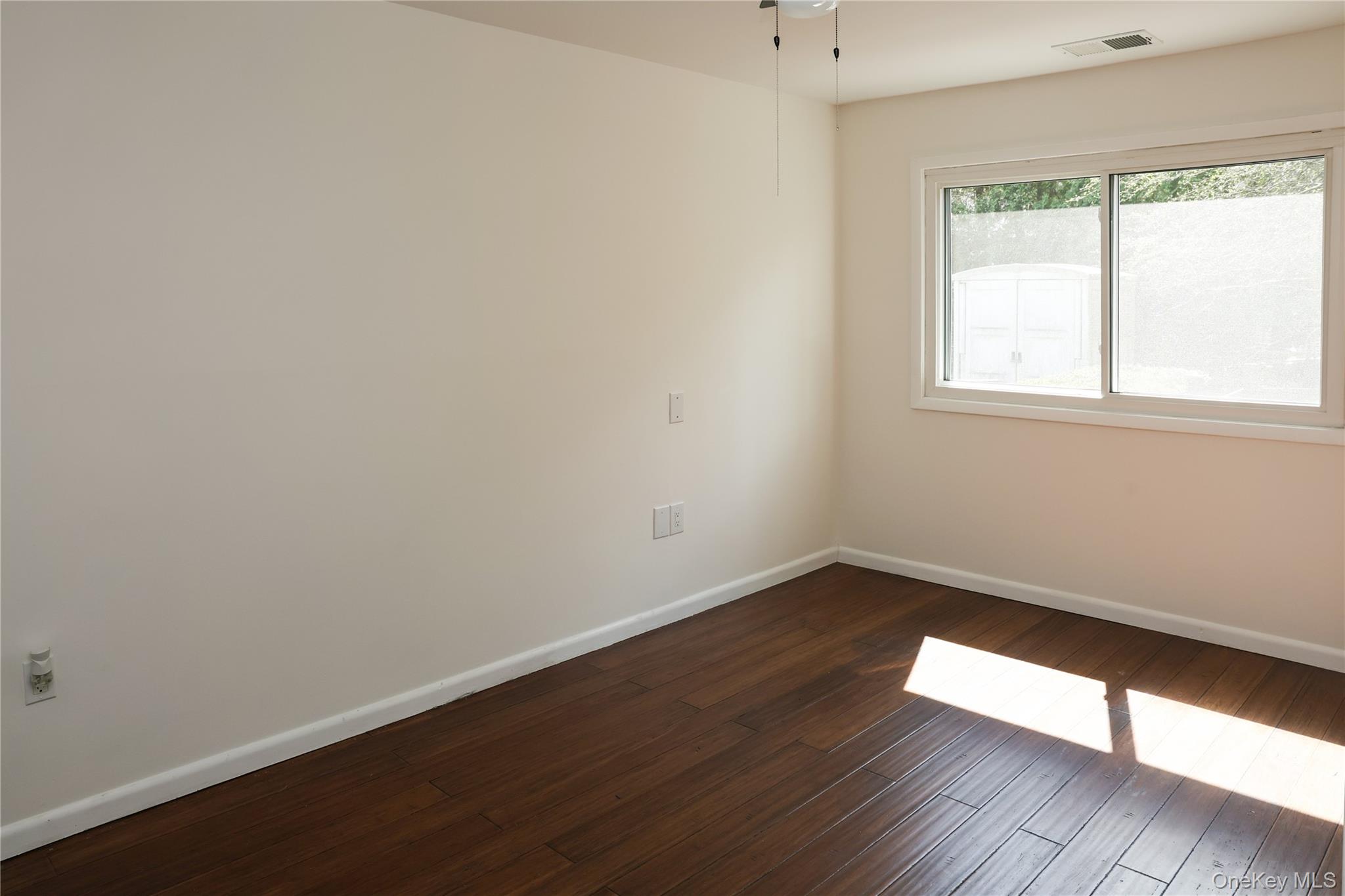 3675 Old Yorktown Road, Unit 13 Shrub Oak, NY 10588 - Photo 22 of 26 an empty room with wooden floor and windows