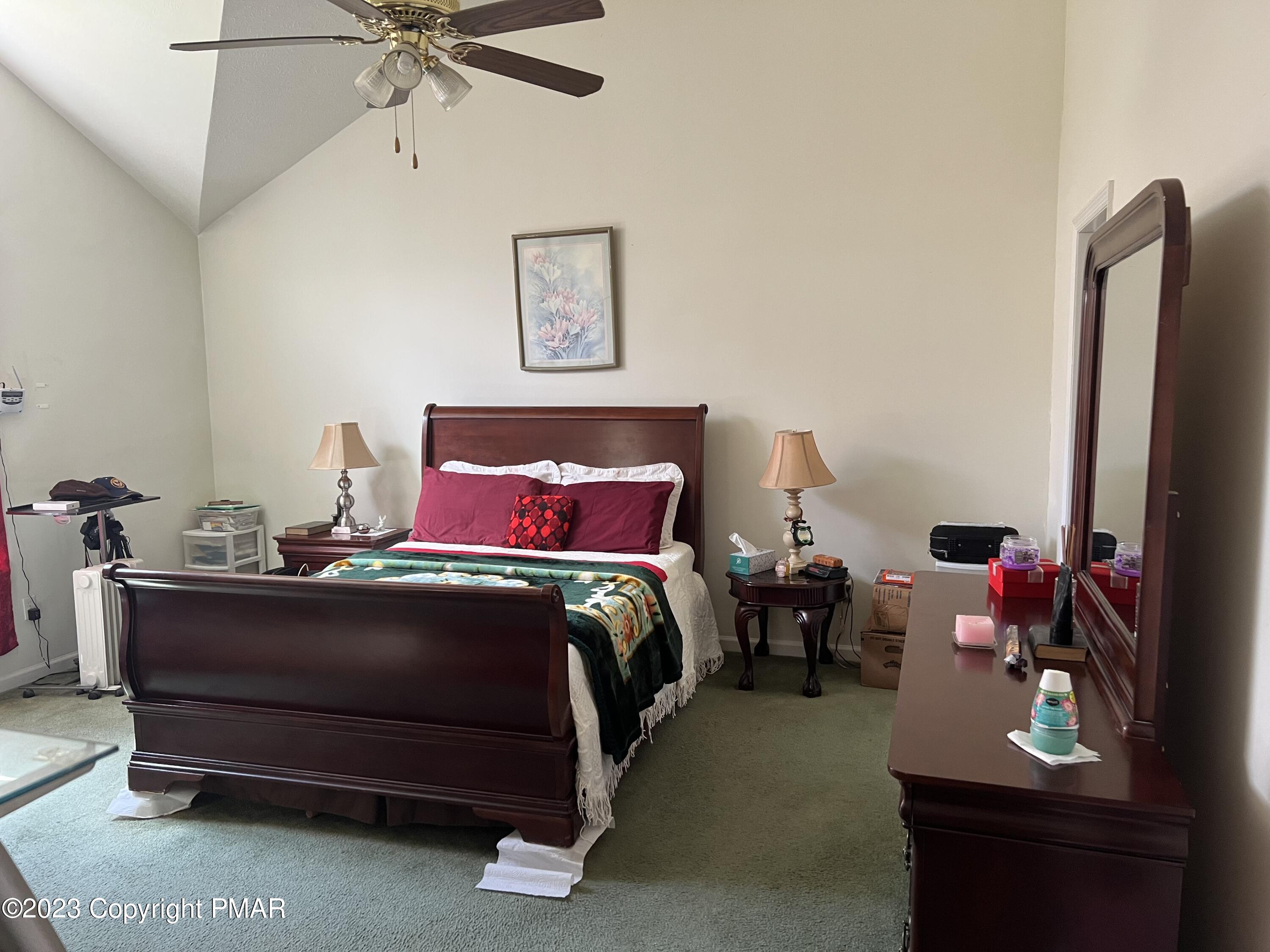 310 Coach Road Tobyhanna, PA 18466 - Photo 16 of 41 a bedroom with a bed and a chandelier
