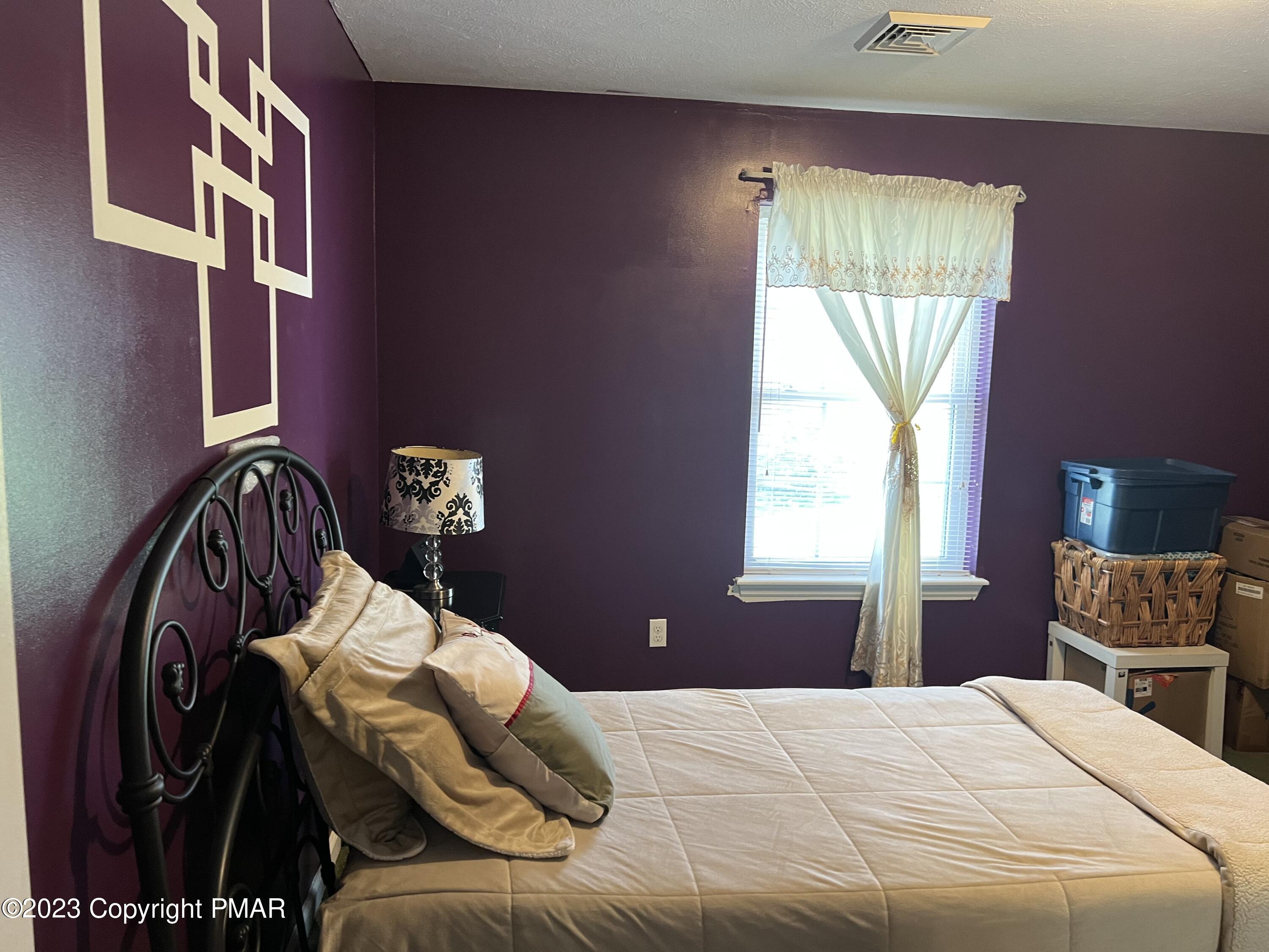 310 Coach Road Tobyhanna, PA 18466 - Photo 4 of 41 a bedroom with a bed and a window