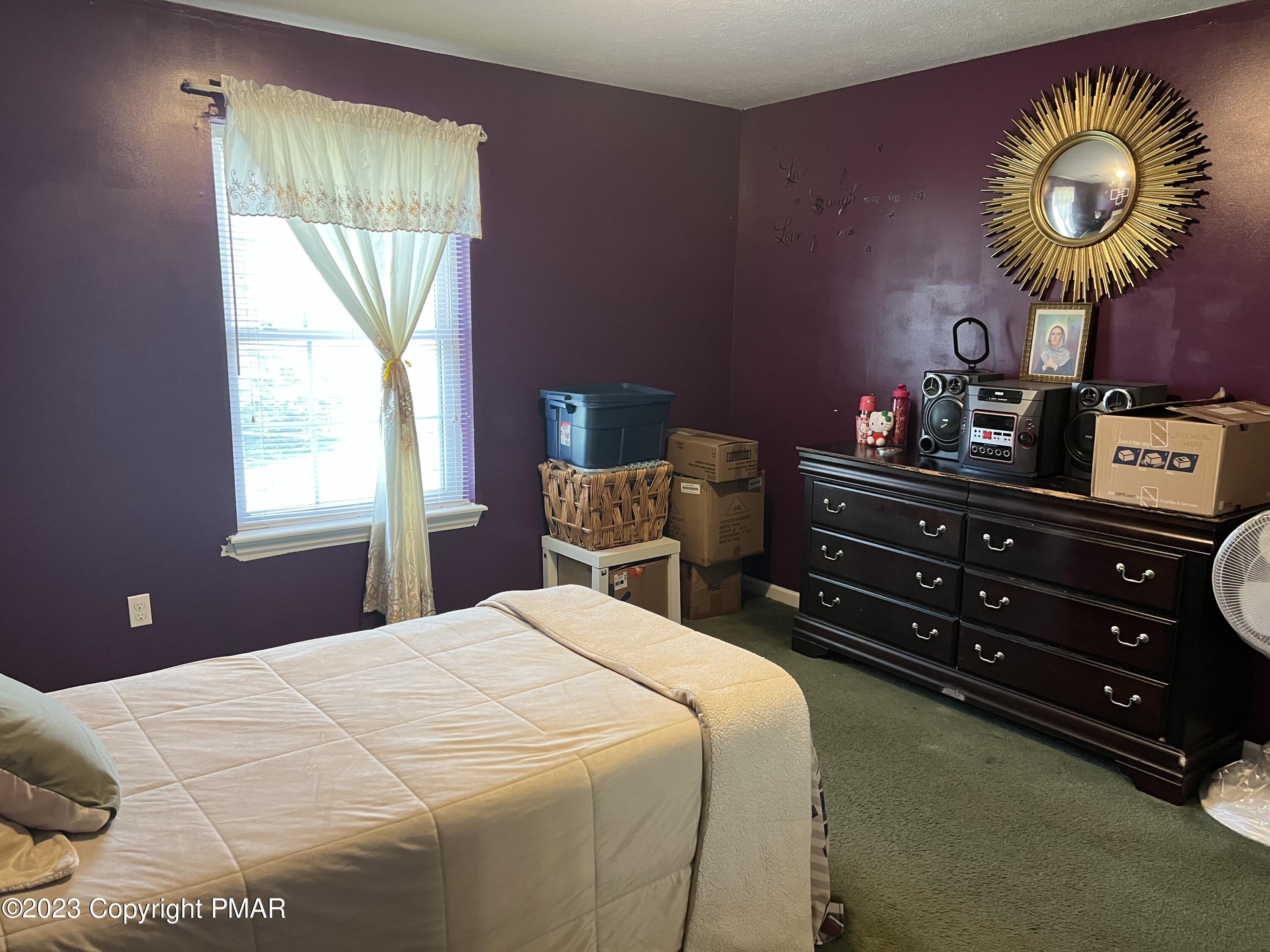 310 Coach Road Tobyhanna, PA 18466 - Photo 5 of 41 a bedroom with a bed and a chandelier