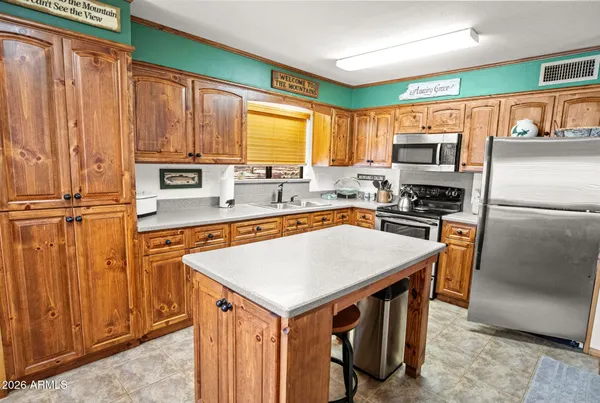 a kitchen with stainless steel appliances granite countertop a refrigerator a stove top oven a sink and dishwasher