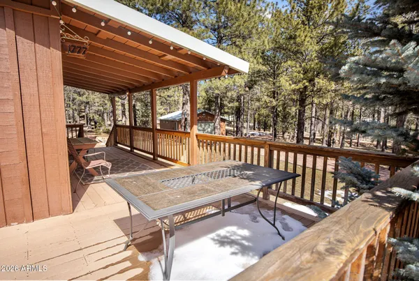 a patio with glass top table and chairs