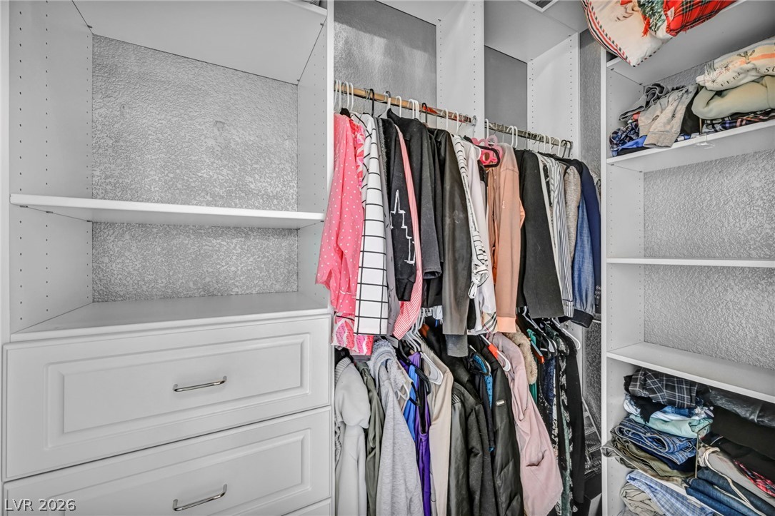 389 Fringe Ruff Drive Las Vegas, NV 89148 - Photo 25 of 53 Custom built-in shelving and integrated drawers maximize storage efficiency in this walk-in closet.