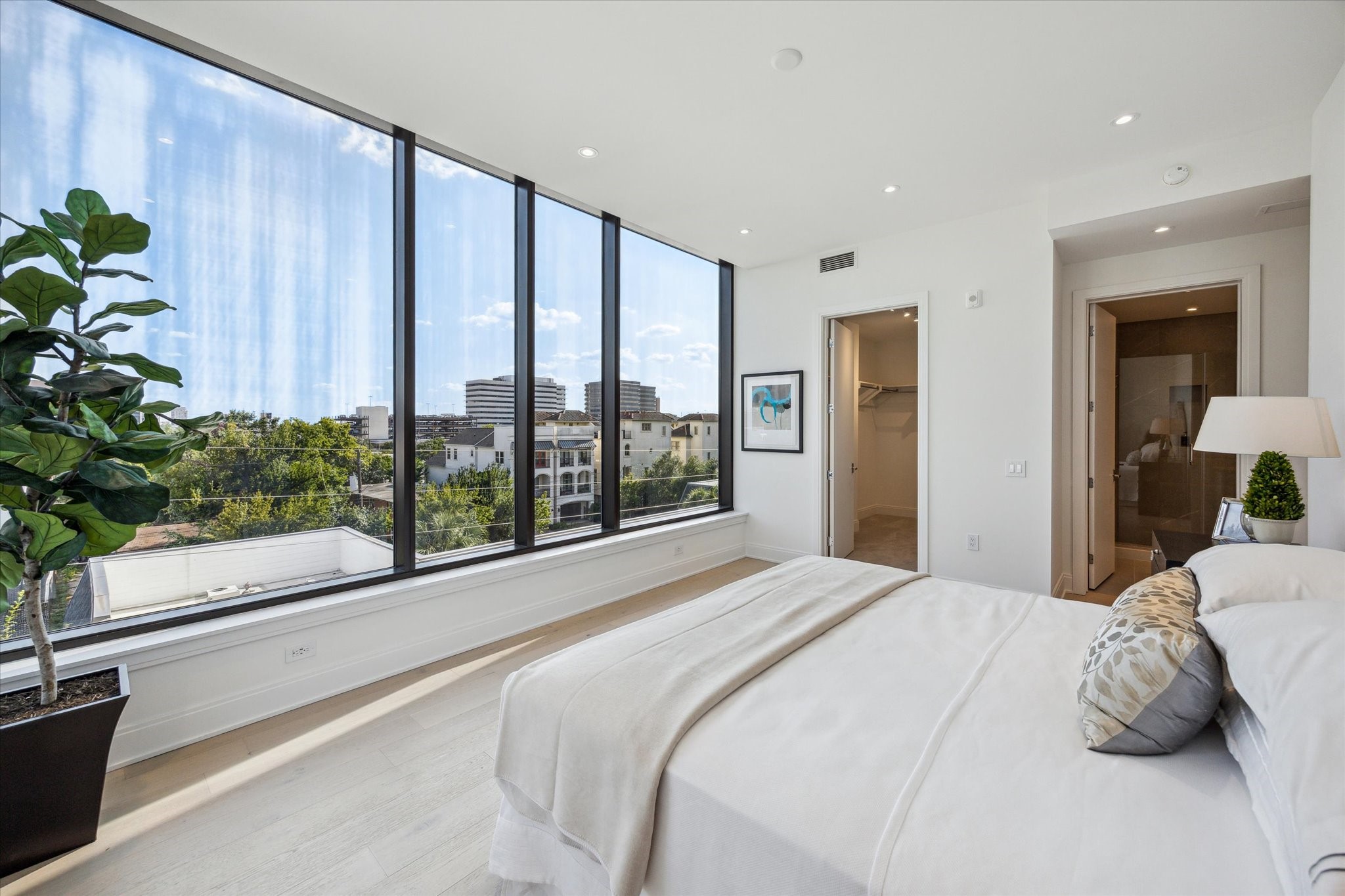 2323 West Main Street, Unit 402 Houston, TX 77098 - Photo 11 of 30 Primary bedroom with south light, large walk-in closet, room for king bed and more.