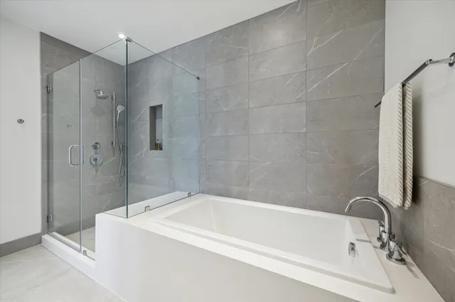 a white bath tub sitting next to a shower