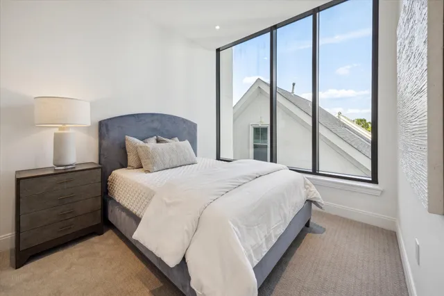 a bedroom with a large bed and a large window