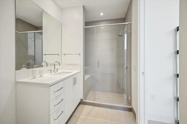 a bathroom with a shower sink and mirror