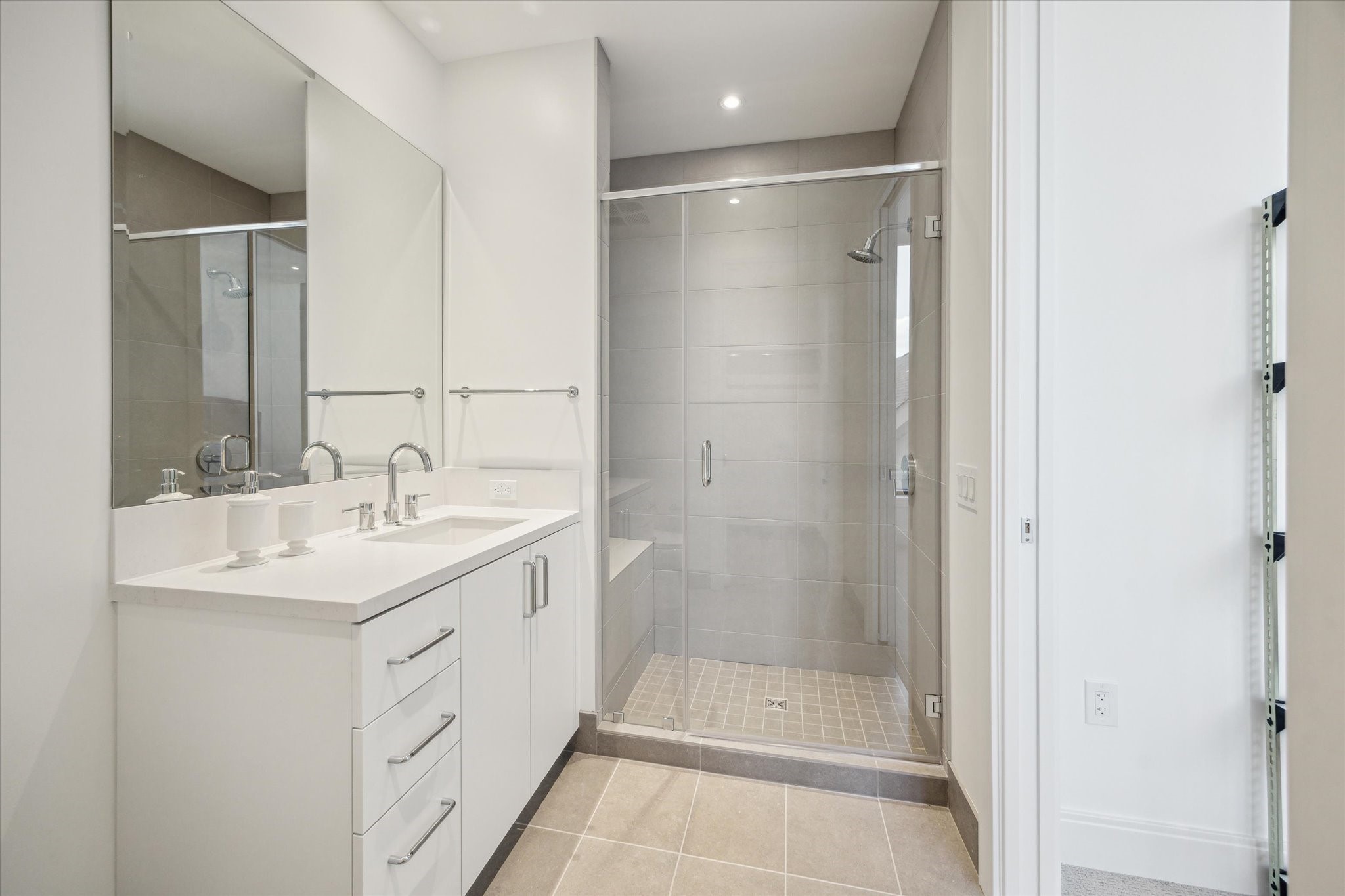 2323 West Main Street, Unit 402 Houston, TX 77098 - Photo 19 of 30 Secondary bedroom en-suite bathroom with generously sized step in shower, porcelain tiles and neutral colors.