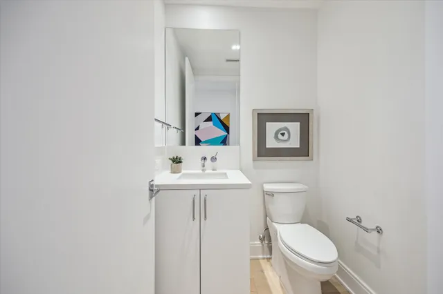 a white toilet sitting next to a bathroom sink