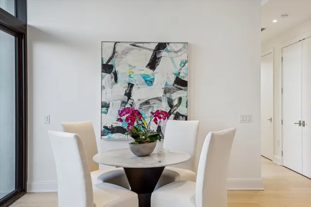 a dining room with furniture and flowers