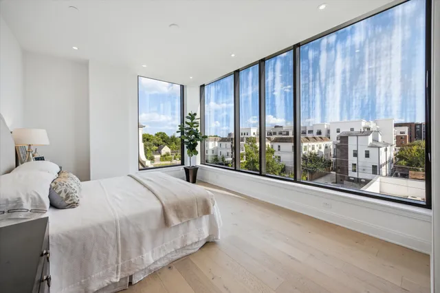 a bedroom with a large bed and a large window