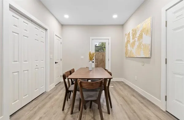 a view of a dining room with furniture and wooden floor