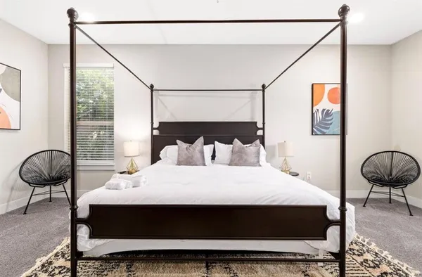 a bedroom with a bed and chair