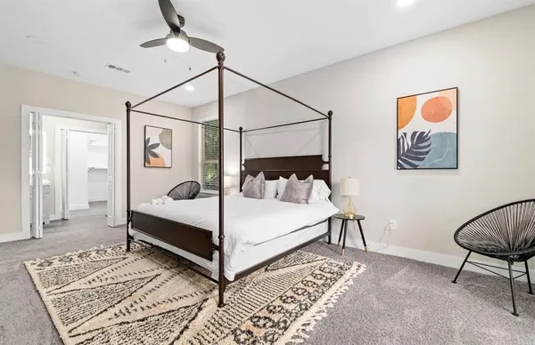 a white bed sitting in a bedroom next to a window