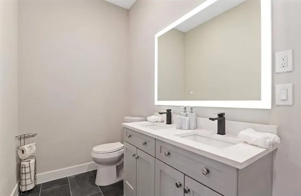 a bathroom with a toilet sink and mirror