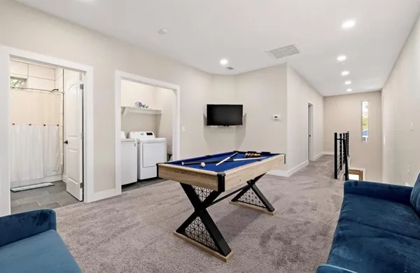 a living room with a couch and a rug