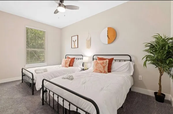 a bedroom with double bed and a potted plant