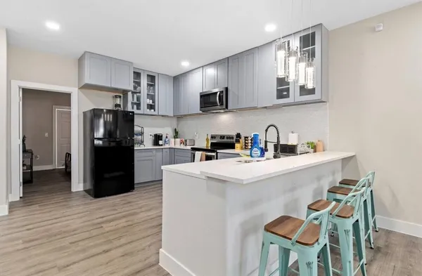 a kitchen with stainless steel appliances granite countertop a refrigerator and a stove top oven