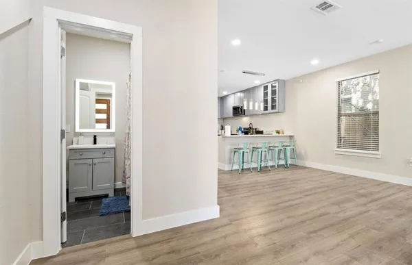 a living room with furniture and a wooden floor