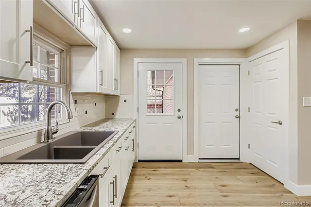 a kitchen with a sink stove top oven and cabinets