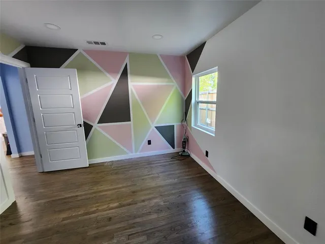 a view of an entryway with wooden floor