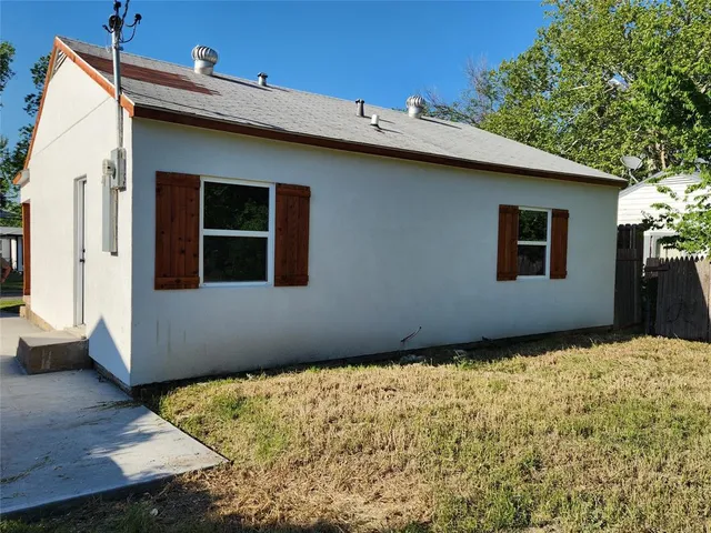 a backyard of a house with large trees