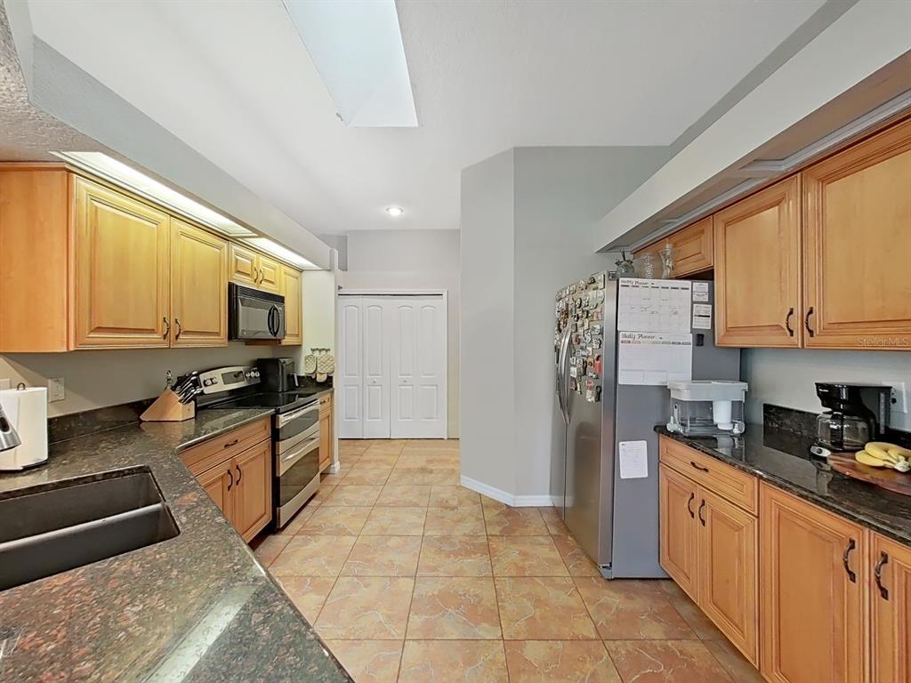9630 Fox Hearst Road Tampa, FL 33647 - Photo 18 of 47 a kitchen with stainless steel appliances granite countertop a stove a sink and a refrigerator