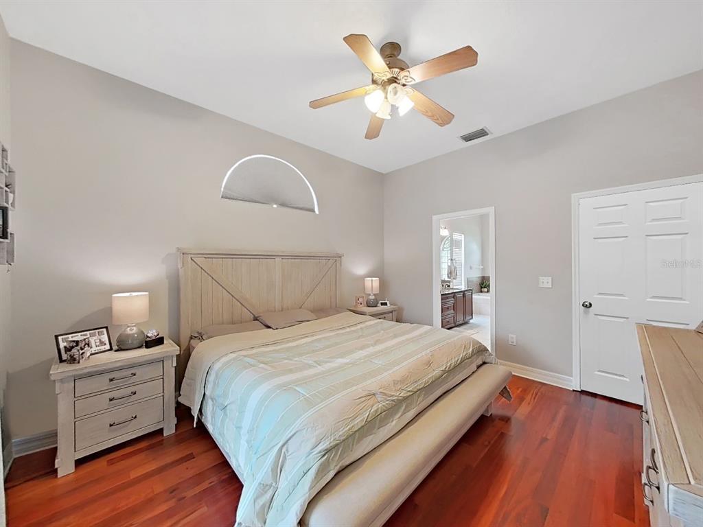 9630 Fox Hearst Road Tampa, FL 33647 - Photo 25 of 47 a bedroom with bed and wooden floor