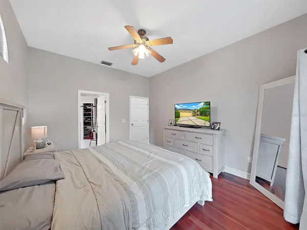 a bedroom with a bed and wooden floor