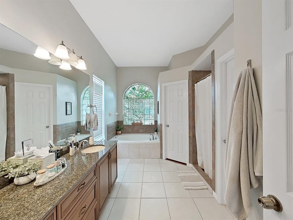 9630 Fox Hearst Road Tampa, FL 33647 - Photo 27 of 47 a large white kitchen with a large window and stainless steel appliances