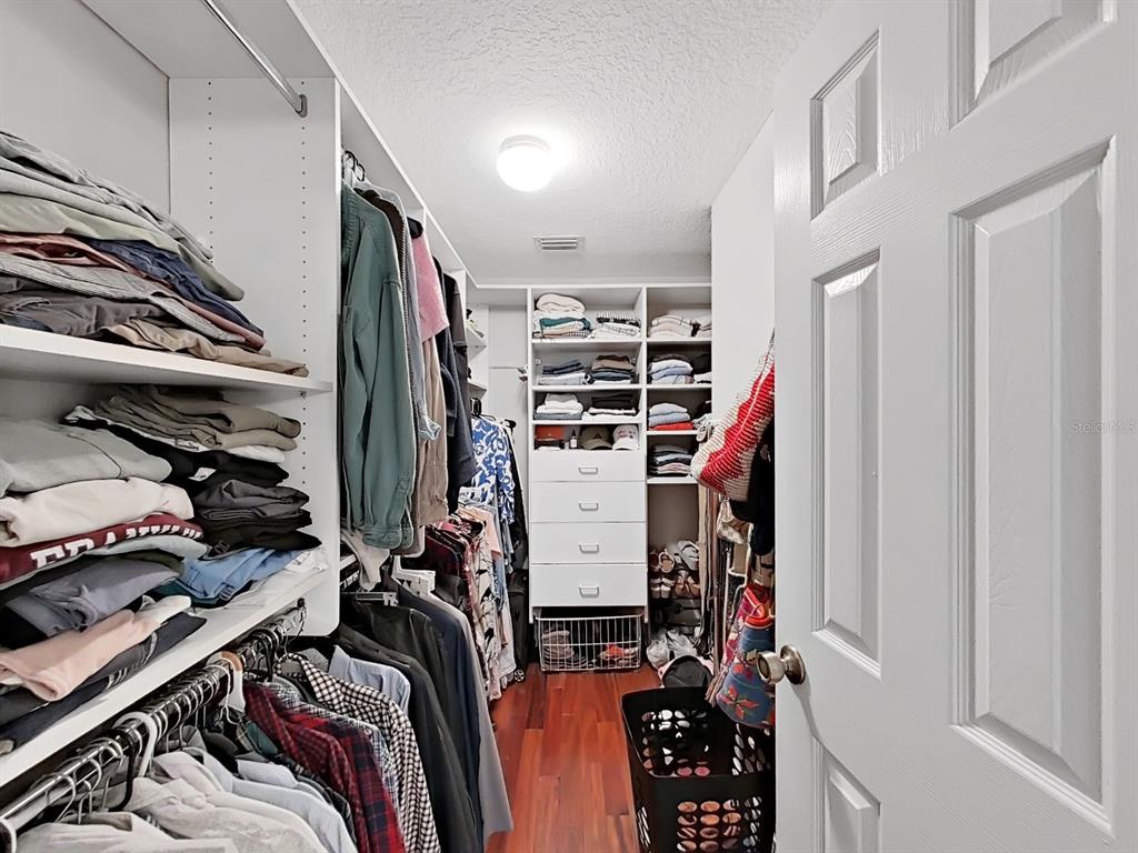 9630 Fox Hearst Road Tampa, FL 33647 - Photo 31 of 47 a view of walk in closet with clothes and shoes