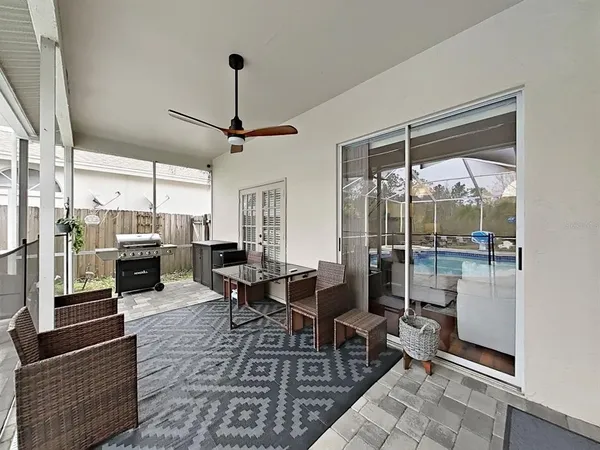 a living room with lots of furniture and a large window