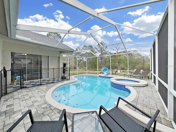 a view of a dining room with furniture wooden floor and a chandelier