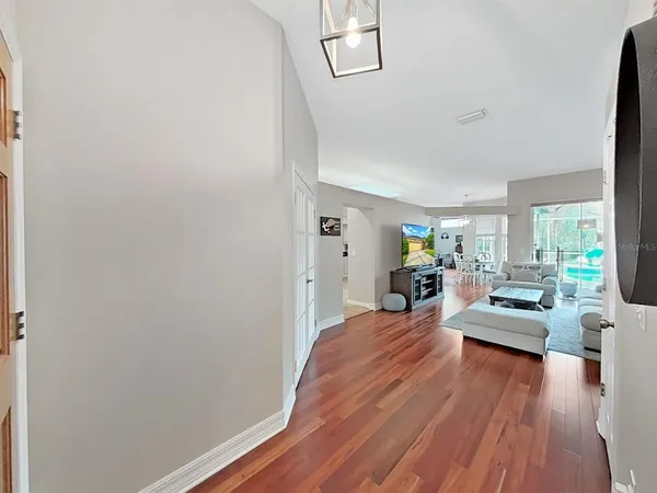 a living room with furniture and a wooden floor