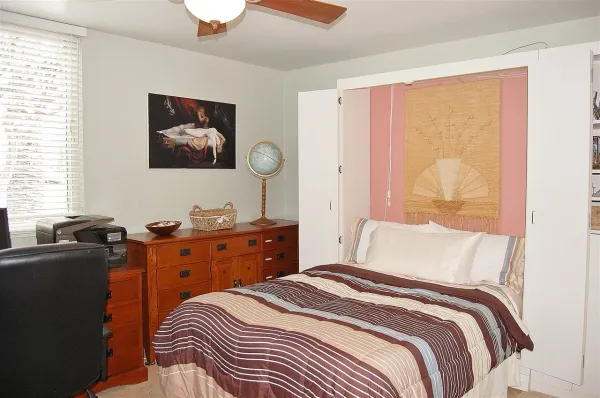 a bedroom with a bed and a dresser