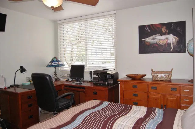 a bedroom with a workspace