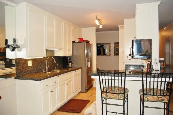 a kitchen with stainless steel appliances a refrigerator sink and cabinets
