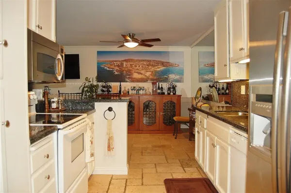 a kitchen with stainless steel appliances granite countertop a stove and cabinets